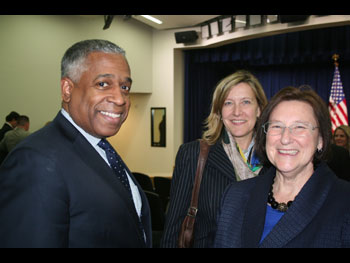 three people at the Medal of Valor award ceremony standing together and smiling at the camera