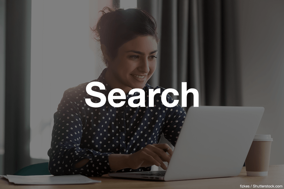 Woman smiling while using a laptop